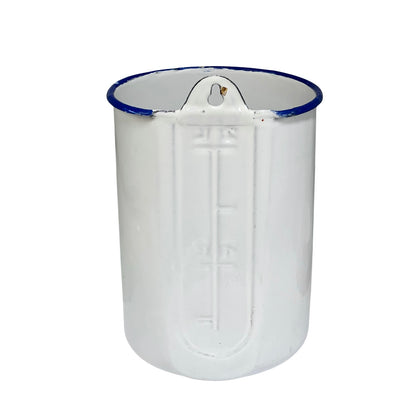 A white enamel pot with a blue rim and embossed measurement markings on the front, shown against a plain white background.