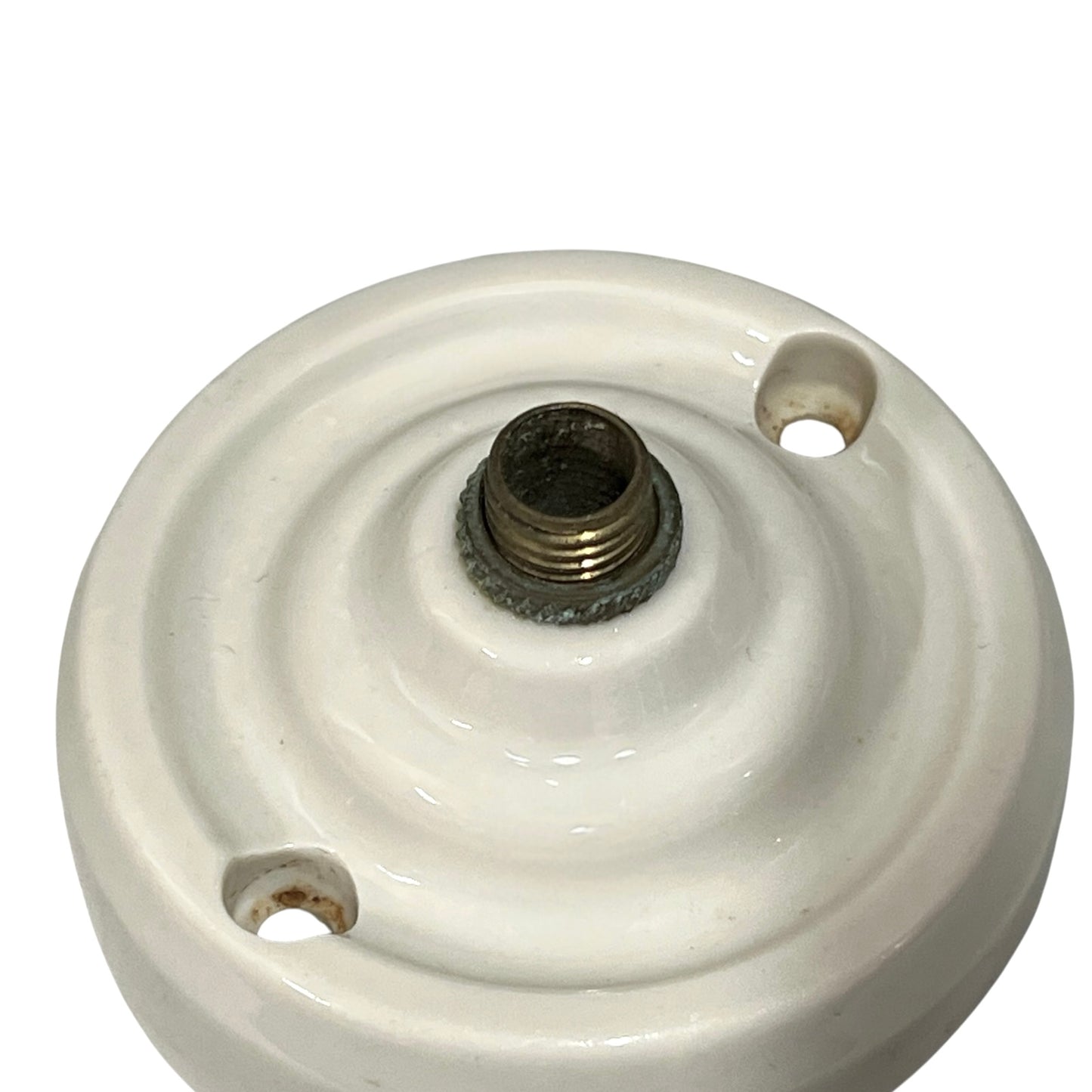 Small vintage French porcelain ceiling rose with a brass nut on a white background 