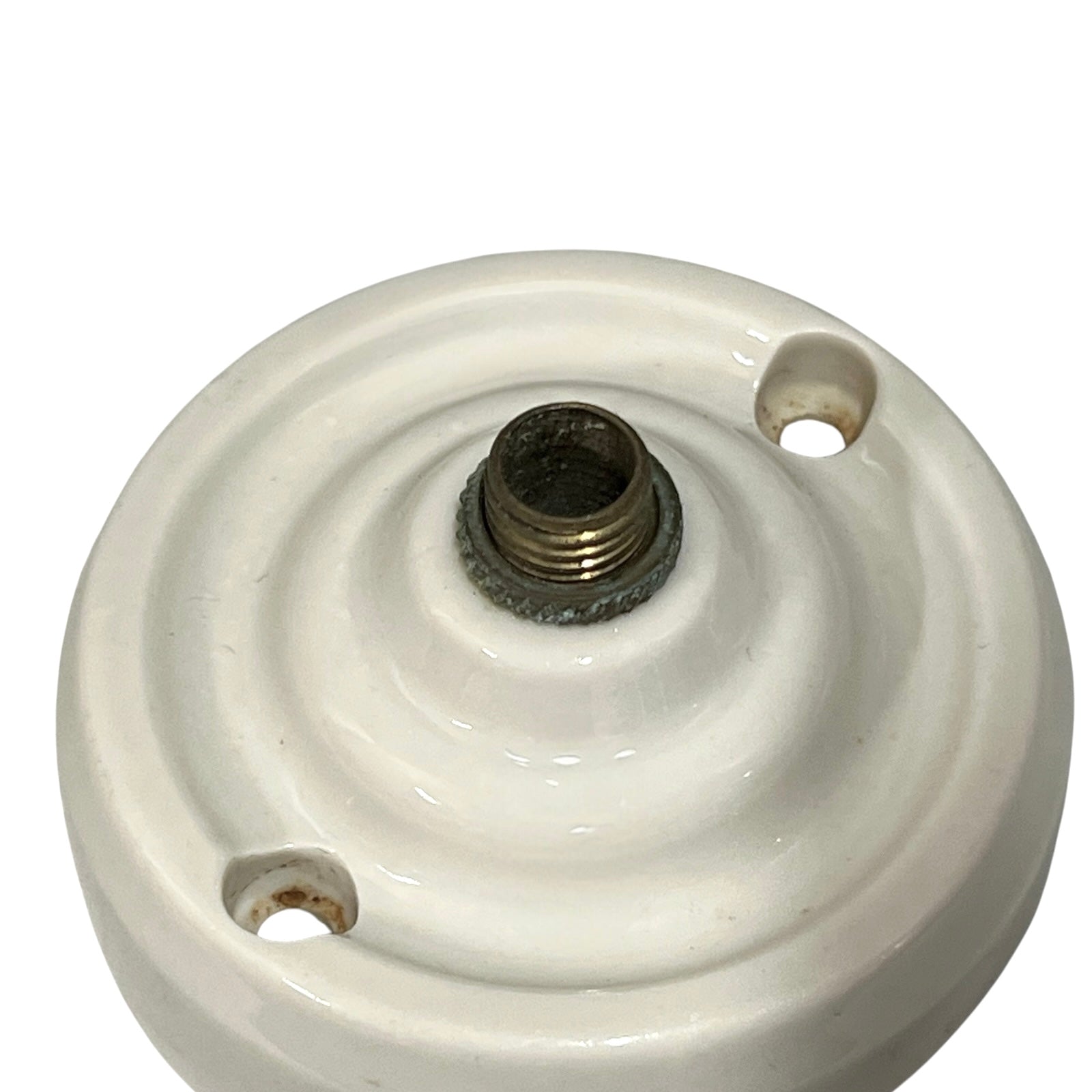 Small vintage French porcelain ceiling rose with a brass nut on a white background 