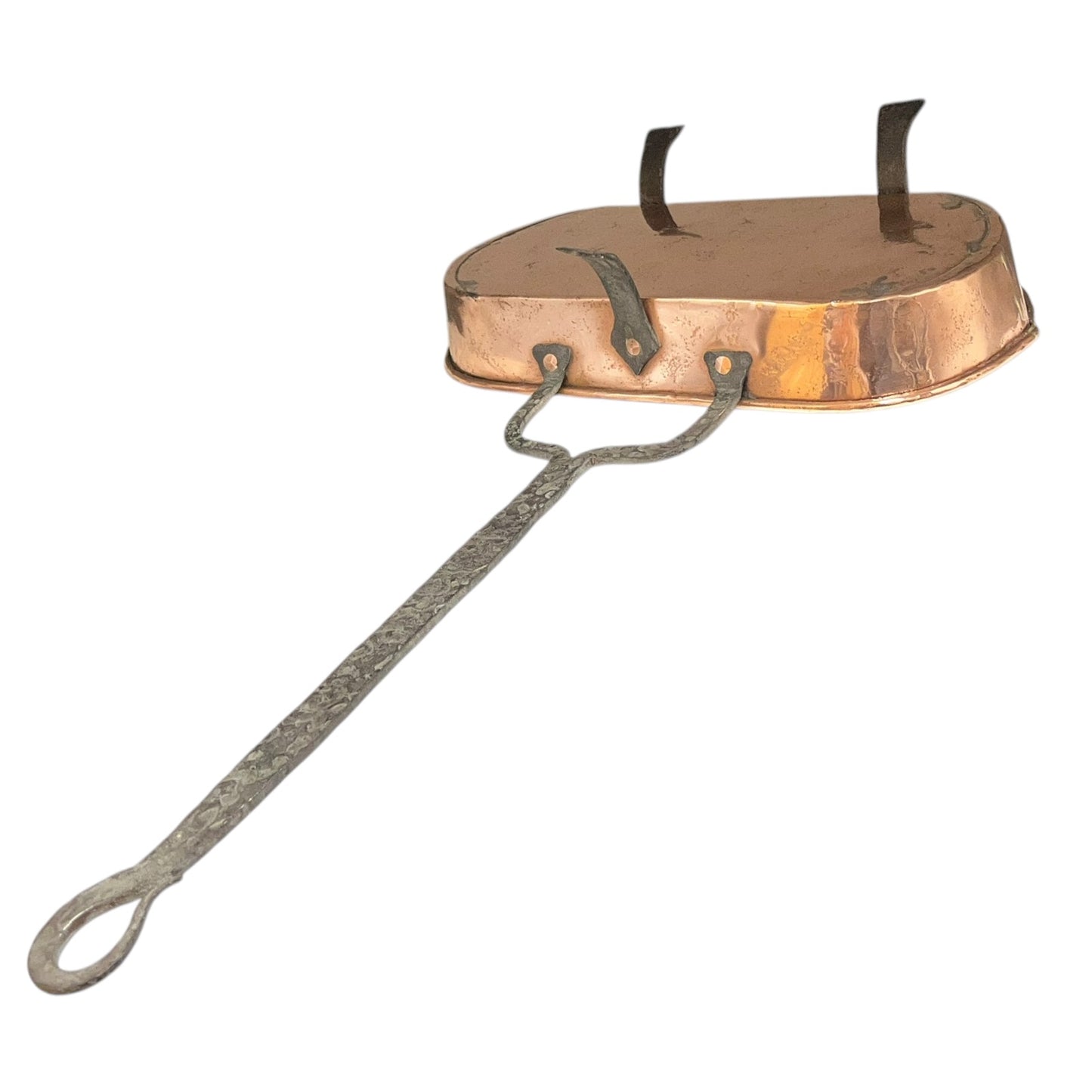 Antique French copper roasting pan with a long handle on a white background