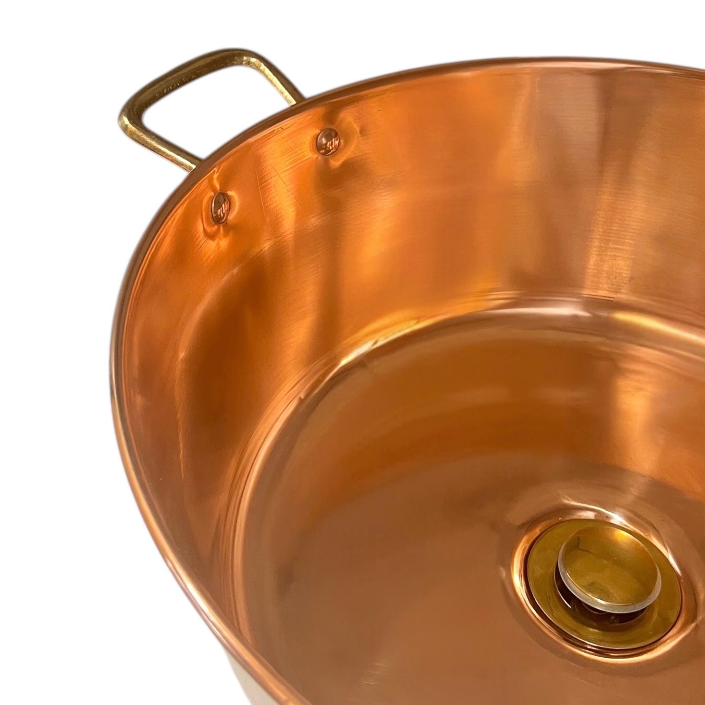 Copper basin with a central drain plug on a white background
