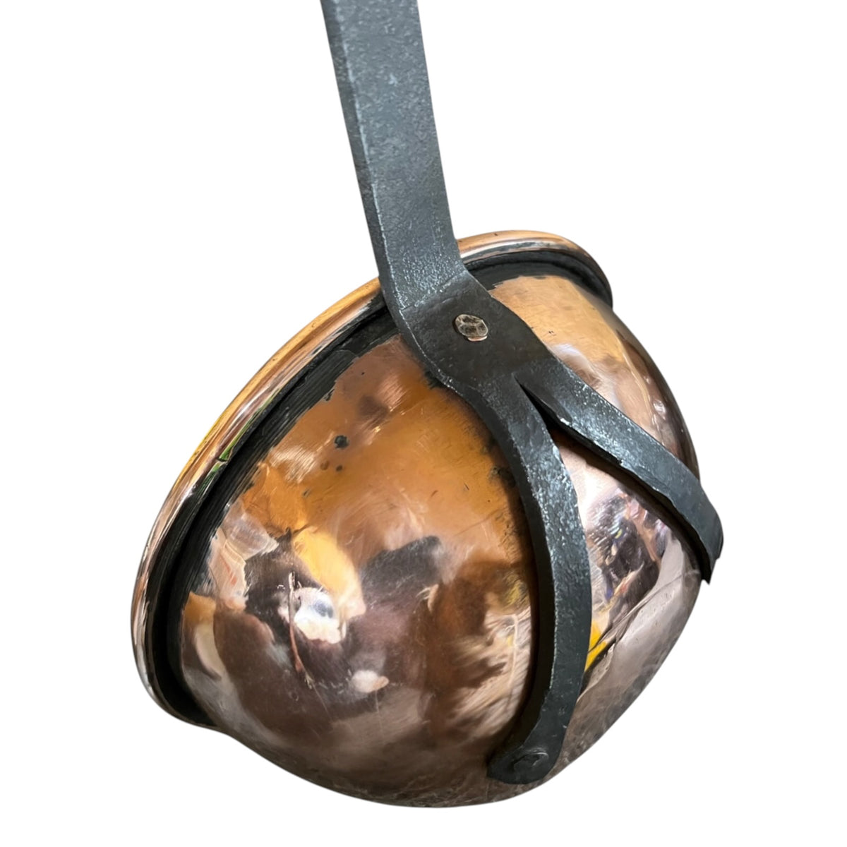 A vintage copper ladle with a dark metal strap and bracket, shown against a plain white background.
