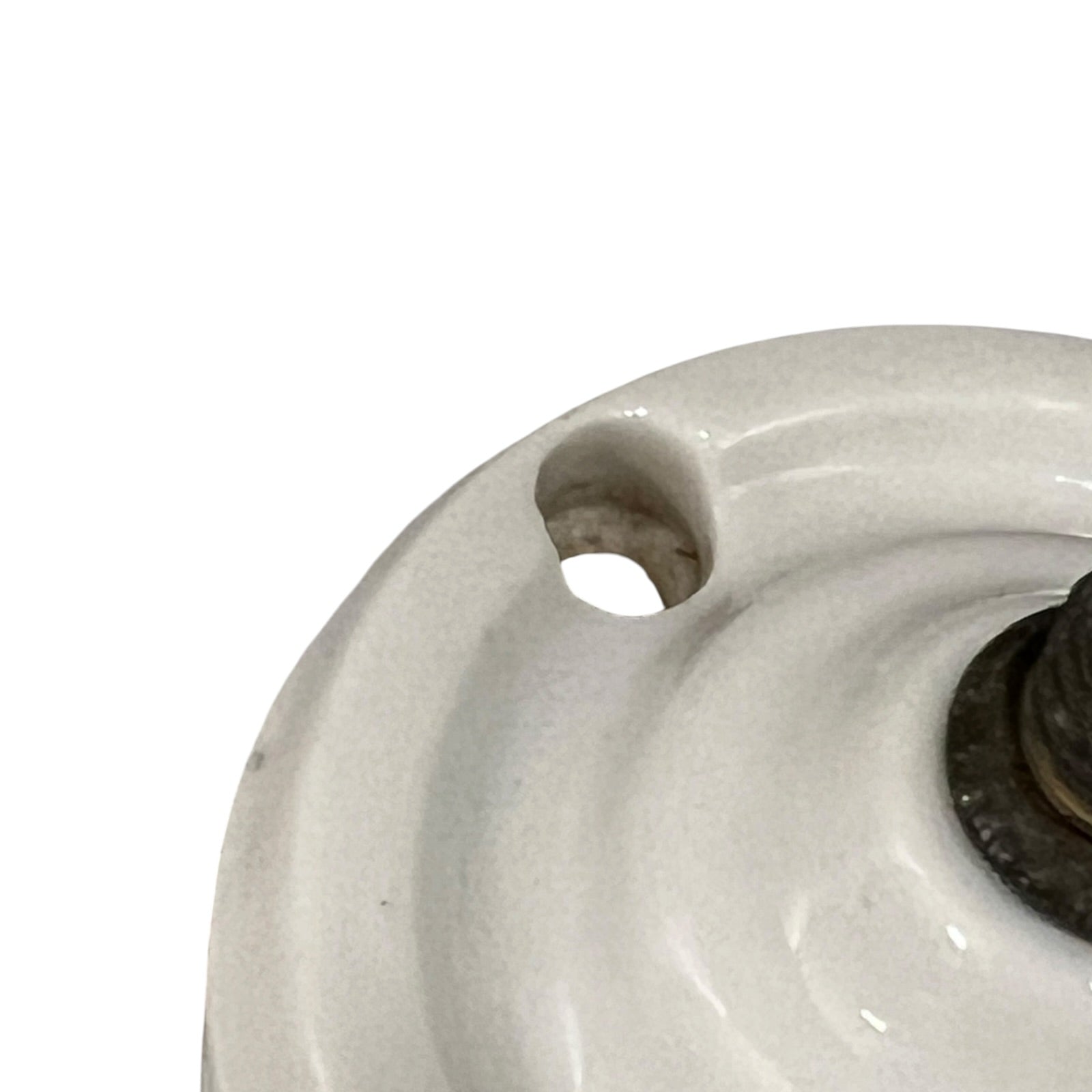 White French porcelain ceiling light rose fitting with a brass screw and 2 screw holes on a white background