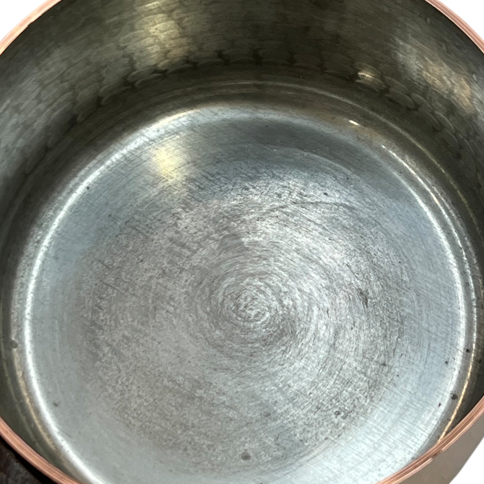 close up of copper pan tin lining