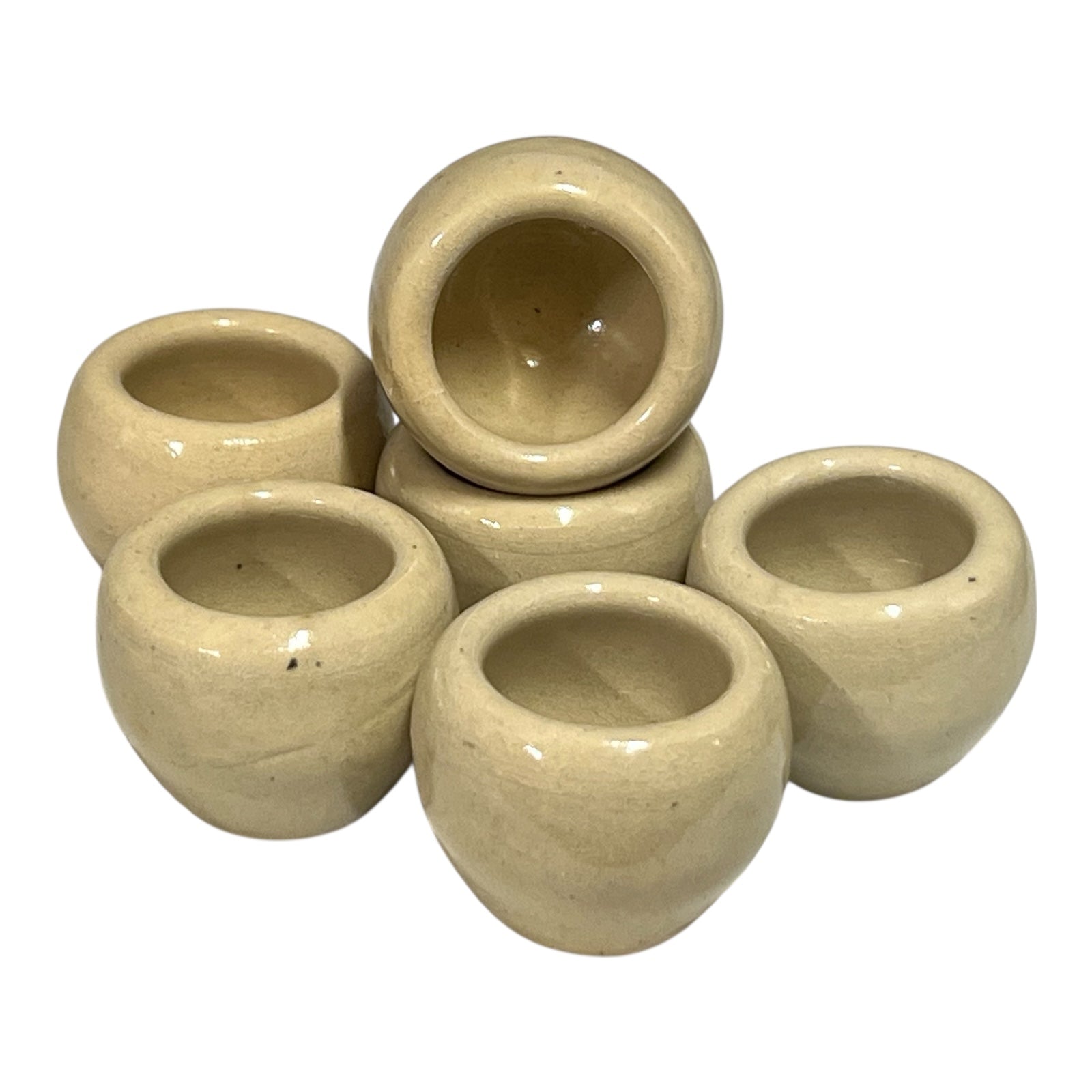 Set of beige ceramic escargots snail cups on a white background