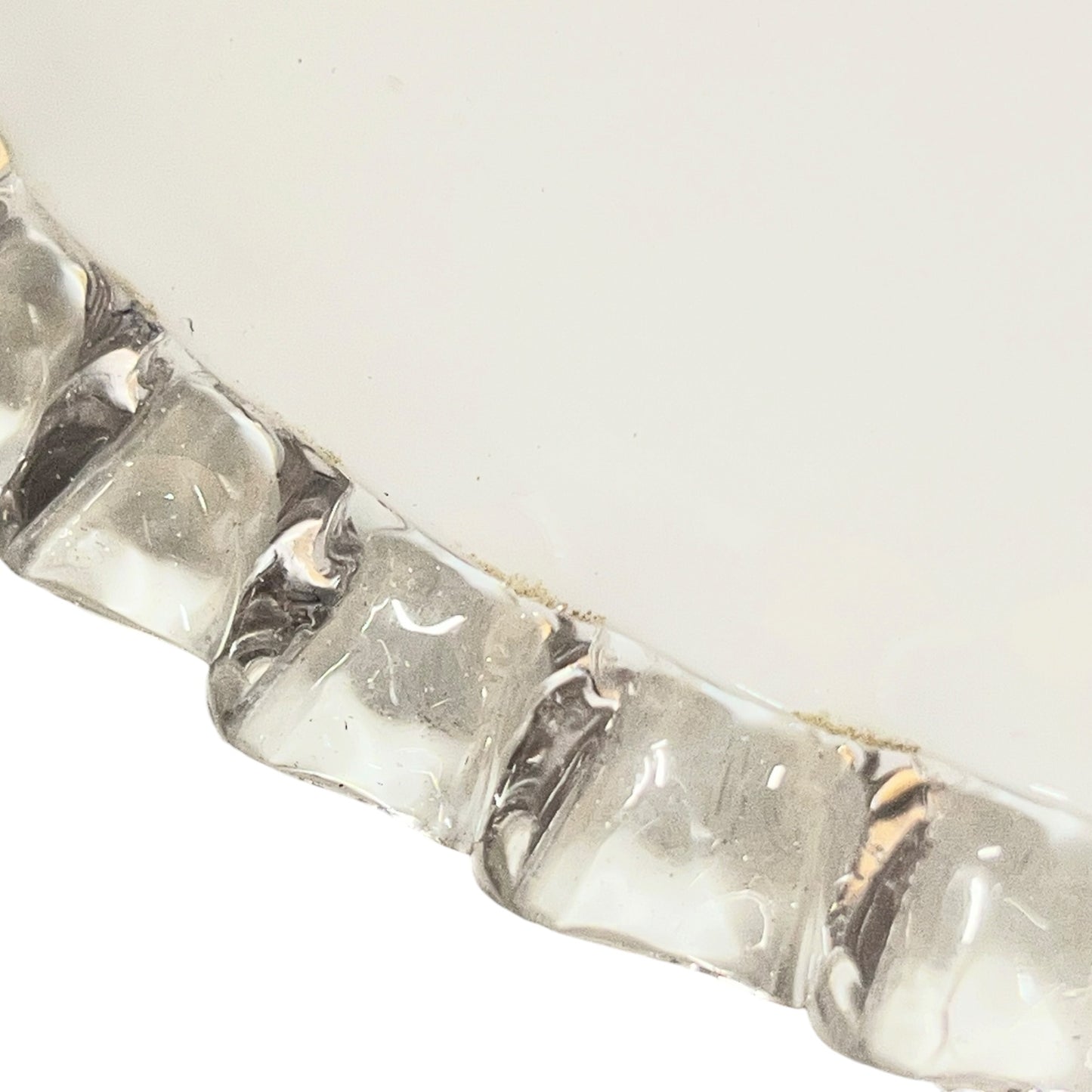 Close-up of a silver bracelet with clear stones on a white background