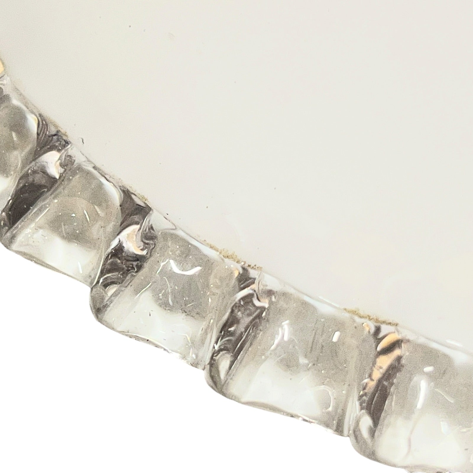 Close-up of a silver bracelet with clear stones on a white background