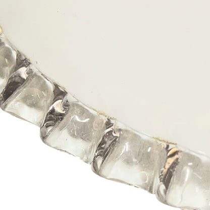 Close-up of a silver bracelet with clear stones on a white background