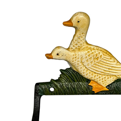 Close up of French farmhouse style goose cast iron toilet roll holder on a white background