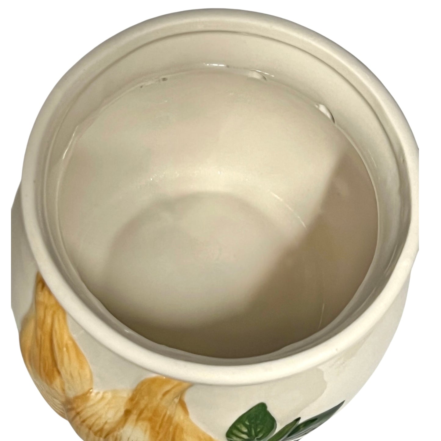 Close-up of a ceramic pot with floral design on a white background
