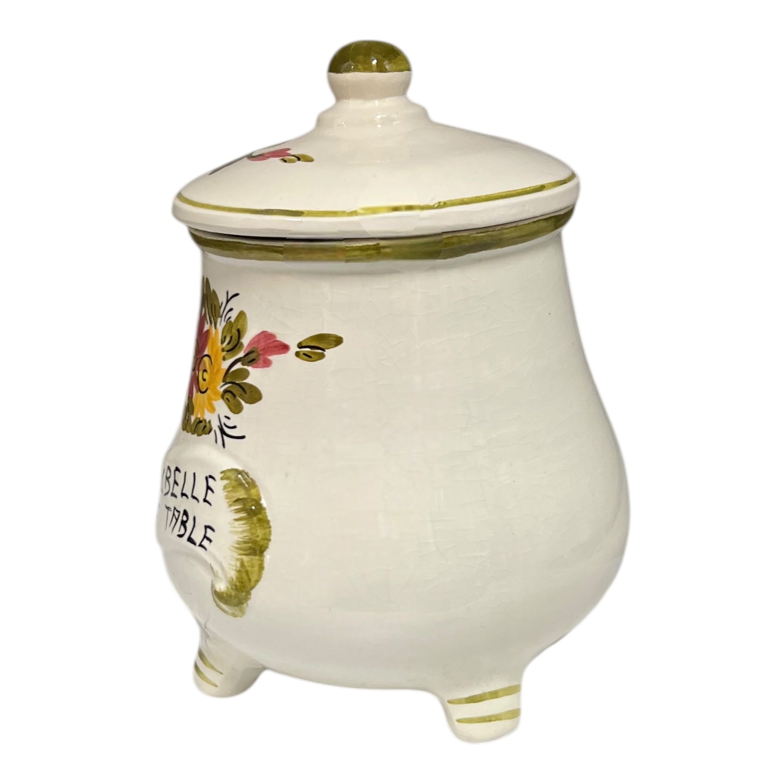 Decorative ceramic jar with floral designs and 'Belle Table' text on a white background