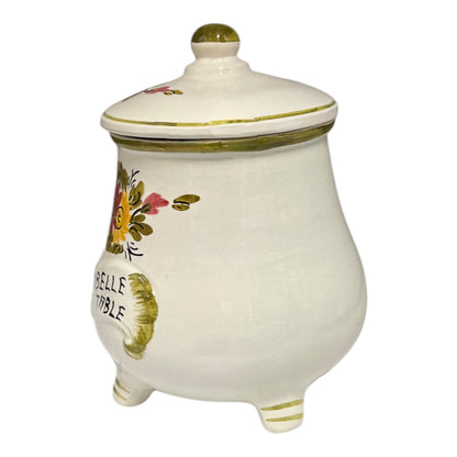 Decorative ceramic jar with floral designs and 'Belle Table' text on a white background