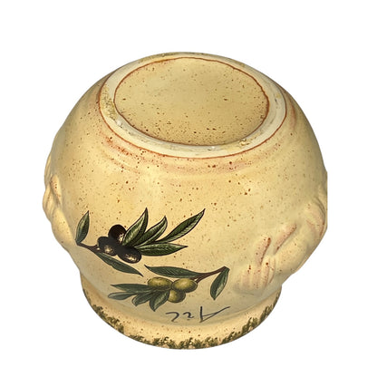 Close-up of a ceramic jar with embossed design on a white background