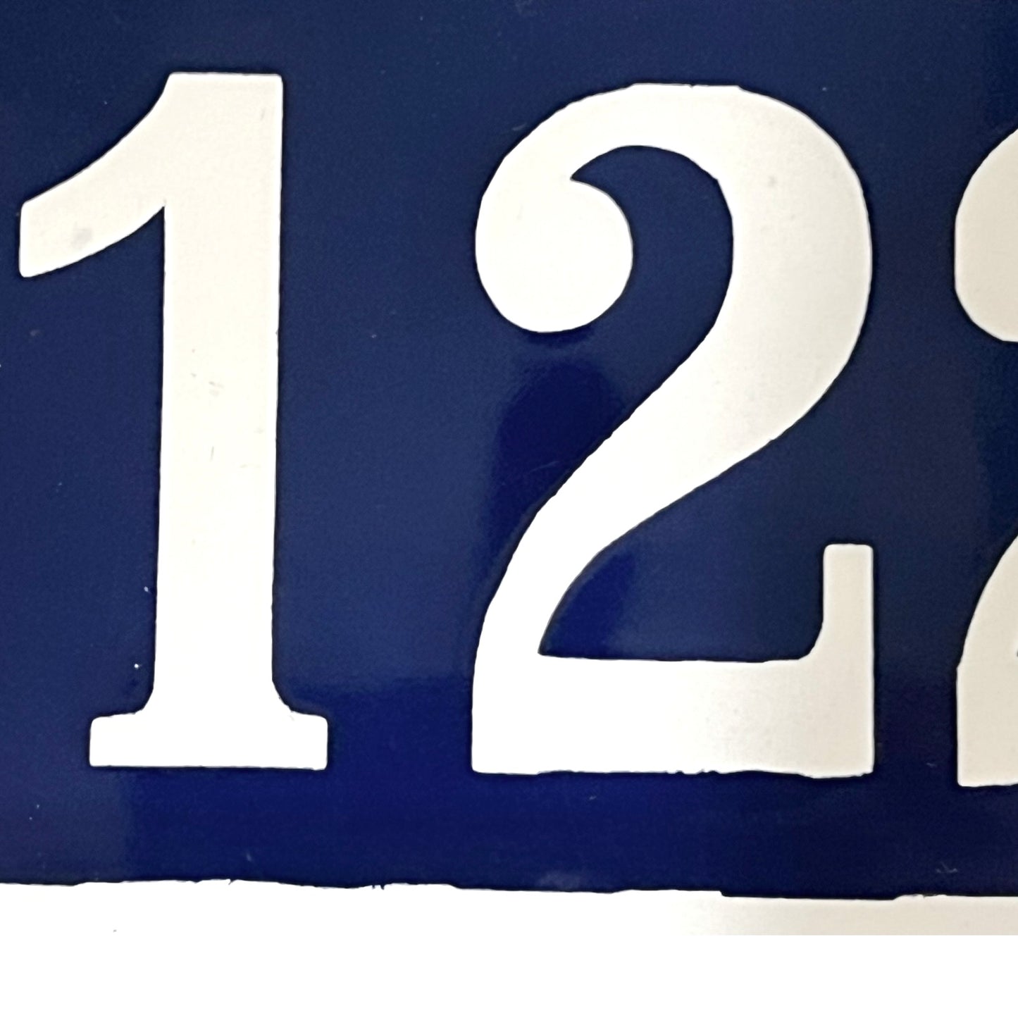 White house numbers '122' on a blue background