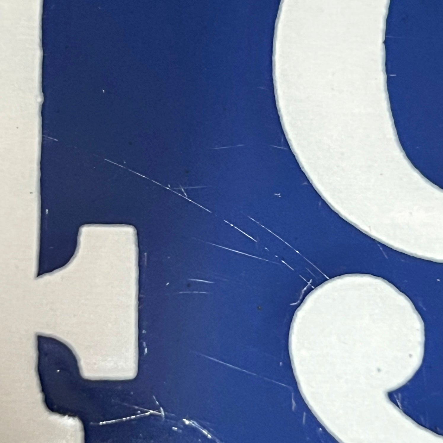 condition view of a vintage French enamel door number against a white background.