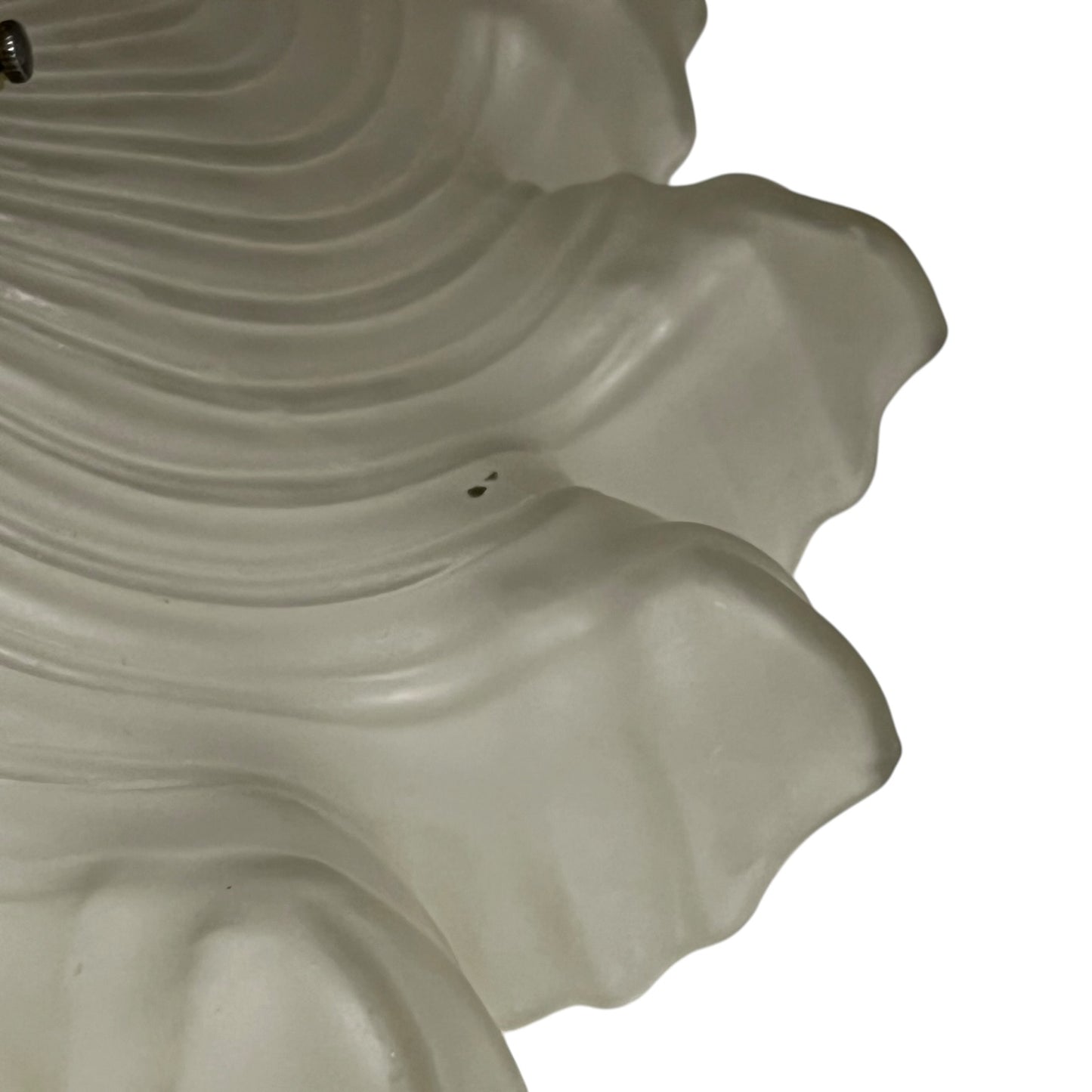 Close up of a vintage-style light fixture with frosted glass shade on a white background