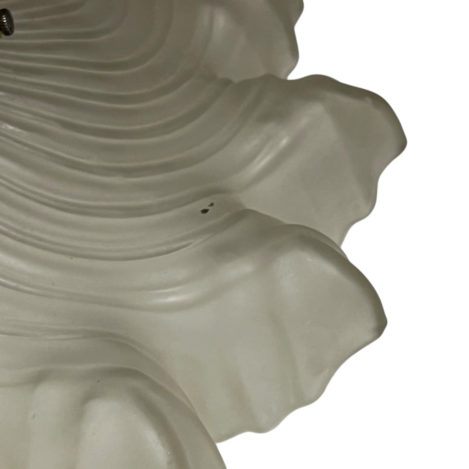Close up of a vintage-style light fixture with frosted glass shade on a white background