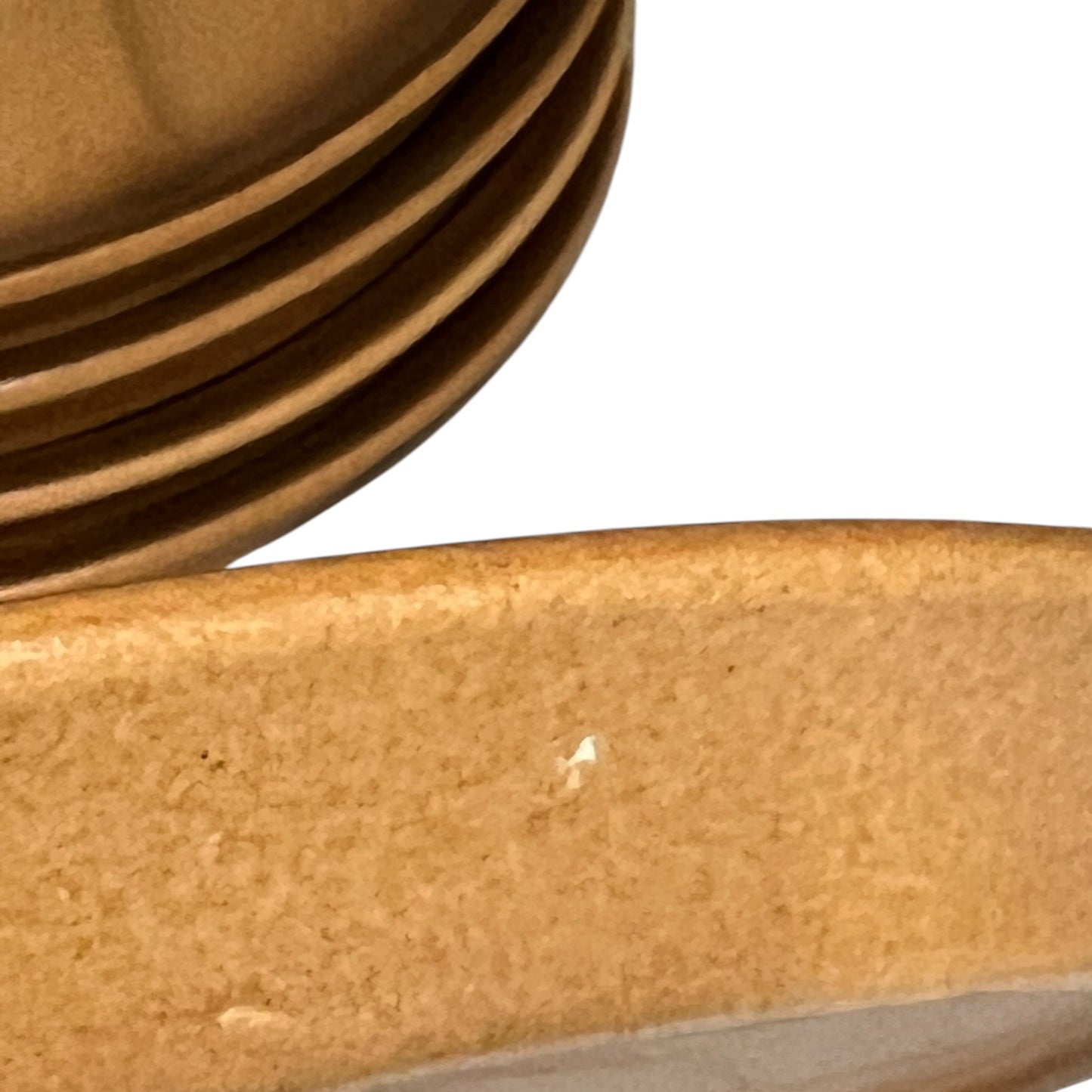 Close-up of a brown textured plate on a white background