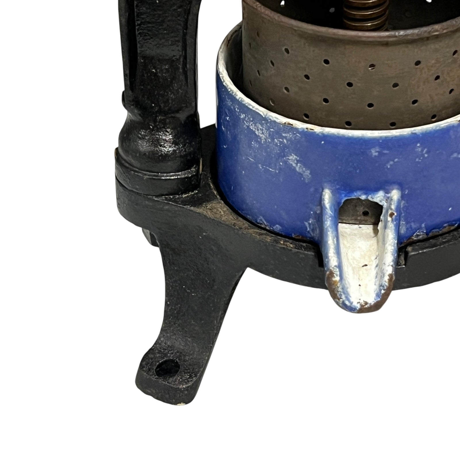Close-up of a vintage fruit press with a black handle on a white background