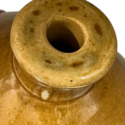 Close-up of a ceramic jar with a textured surface on a white background