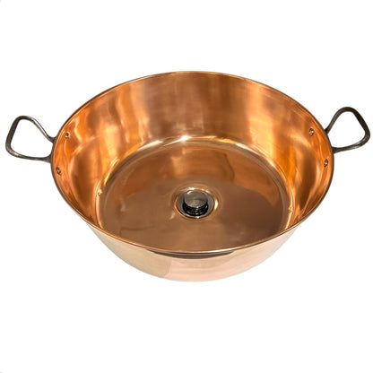 Copper bathroom sink up cycled from a French jam pan on a white background
