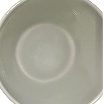 Close up of a fondue pan on a white background