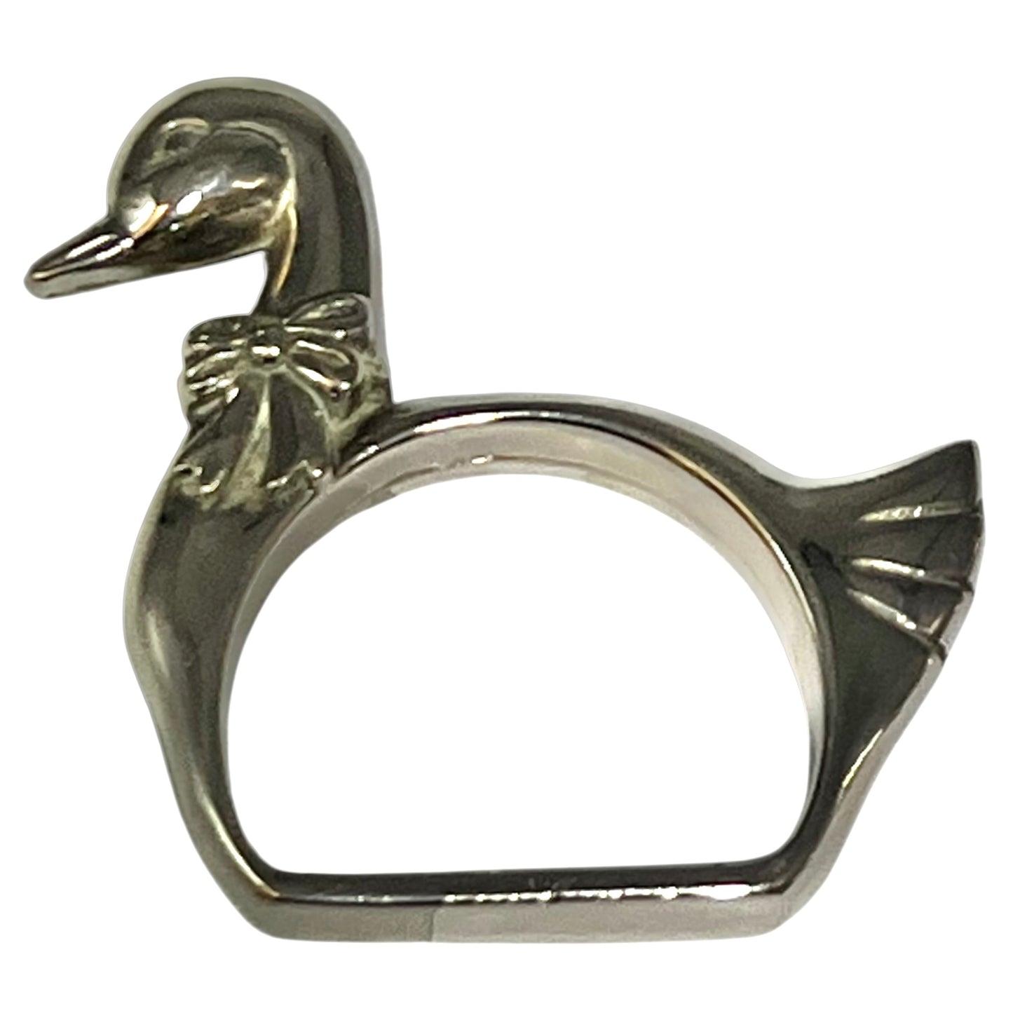 Close-up of a swan shaped silver plated napkin ring on a white background