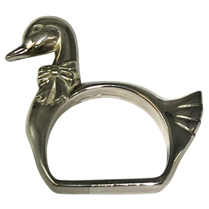 Close-up of a swan shaped silver plated napkin ring on a white background