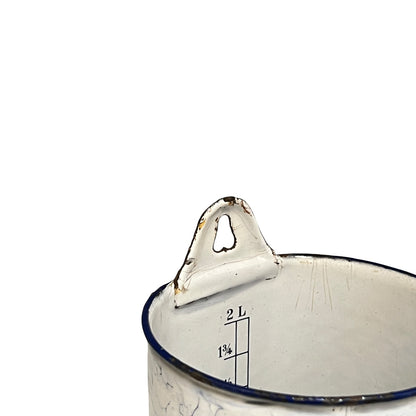 Close up of a French enamel vintage garden wall mounted planter or kitchen bathroom storage pot, on a white background 