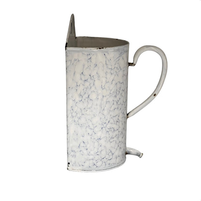 Side view of a  vintage-style white enamel planter with a blue crackle pattern, a metal top loop, a side handle, and a small spout, shown on a plain white background.