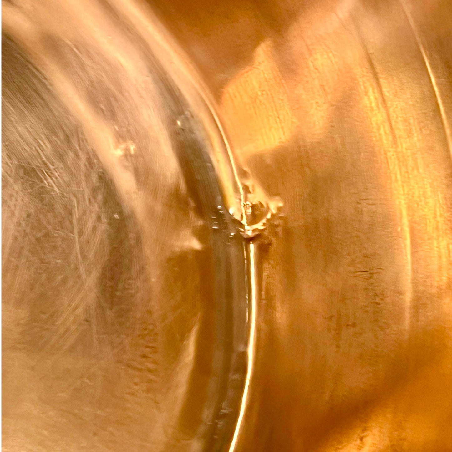 Close-up of a copper sink with a drain plug