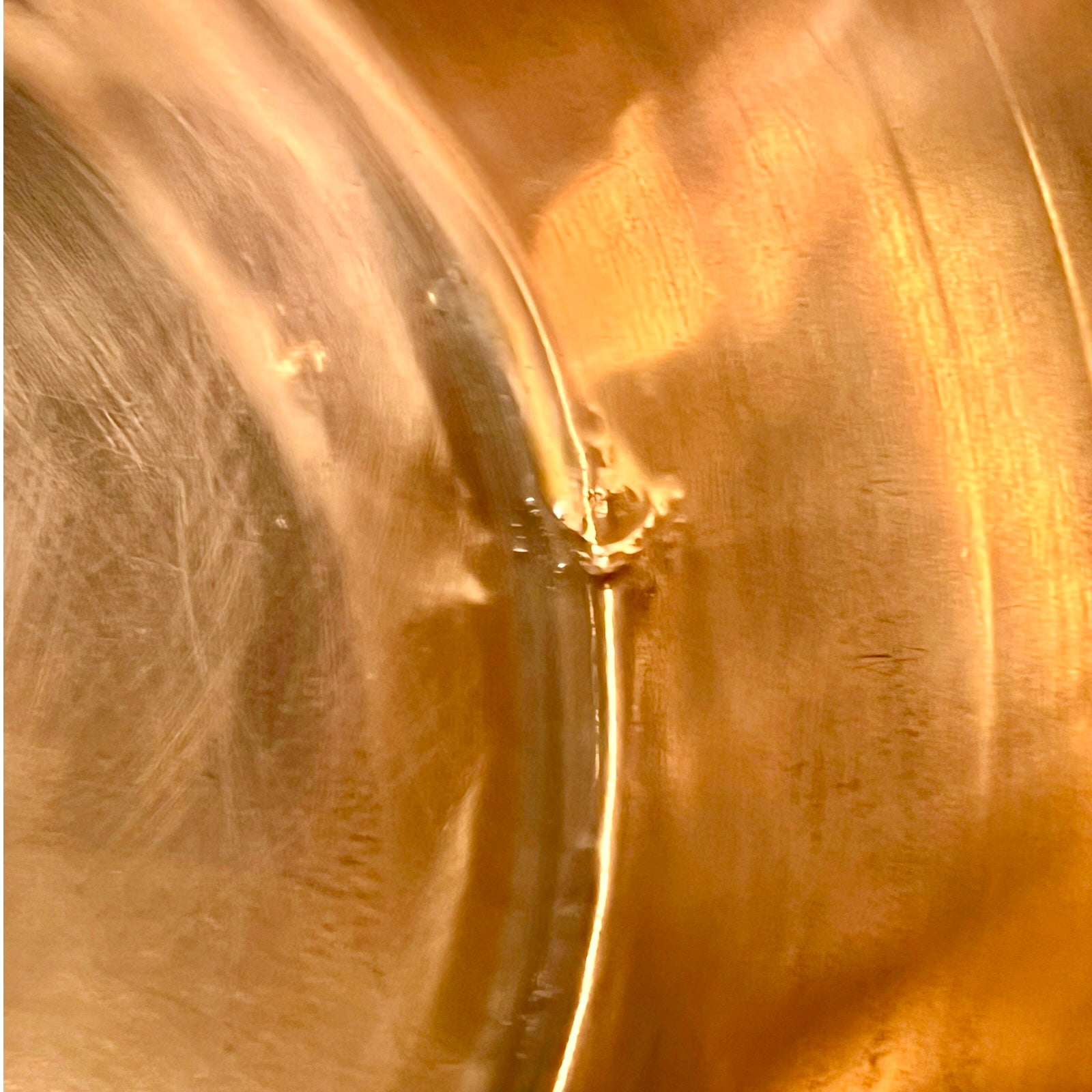 Close-up of a copper sink with a drain plug