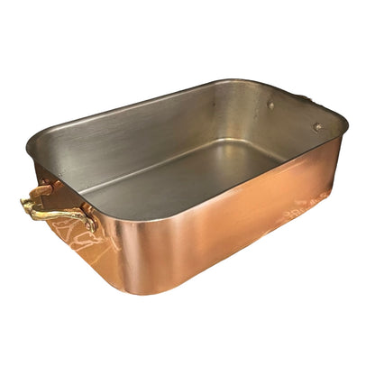 Copper roasting pan with a handle on a white background