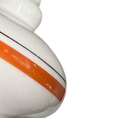 Close-up of a ceramic pitcher with an orange stripe and black line on a white background