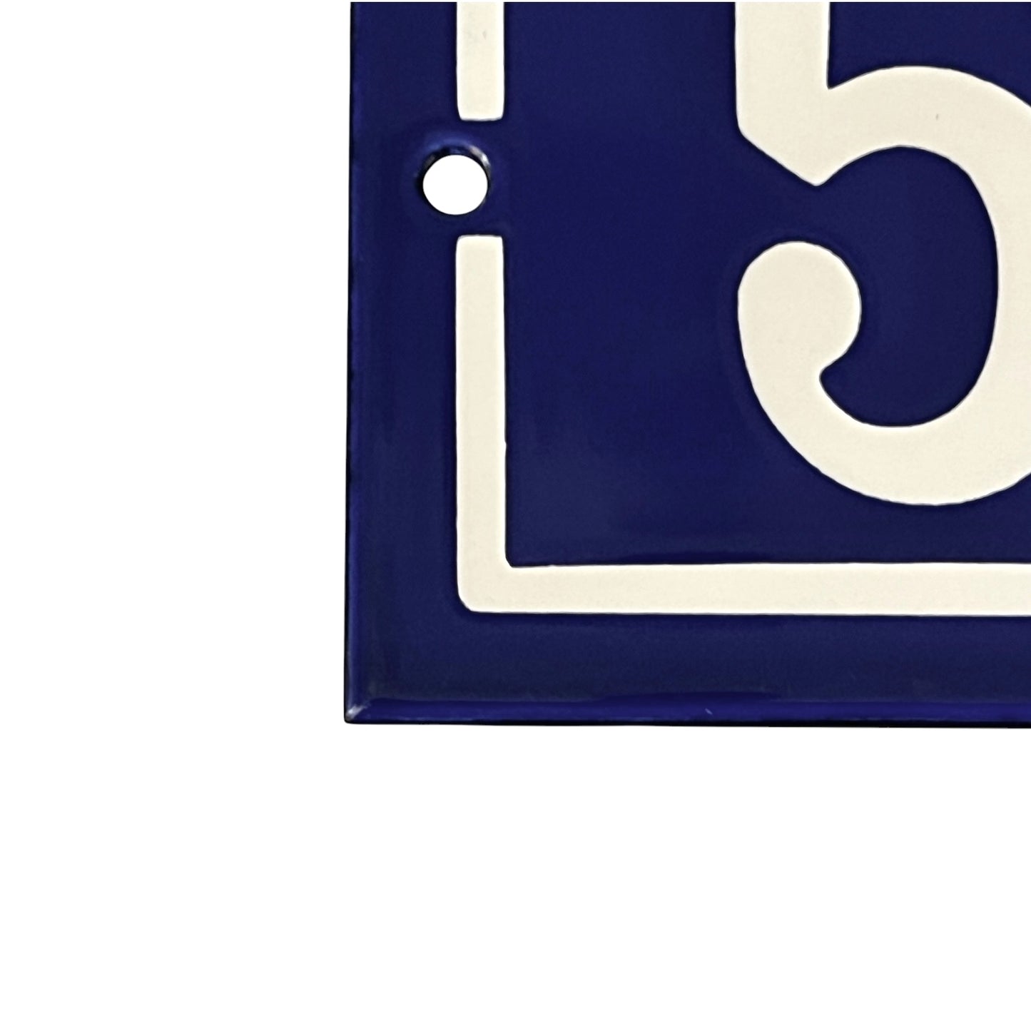 Close up of a French blue and white door number on a white background 