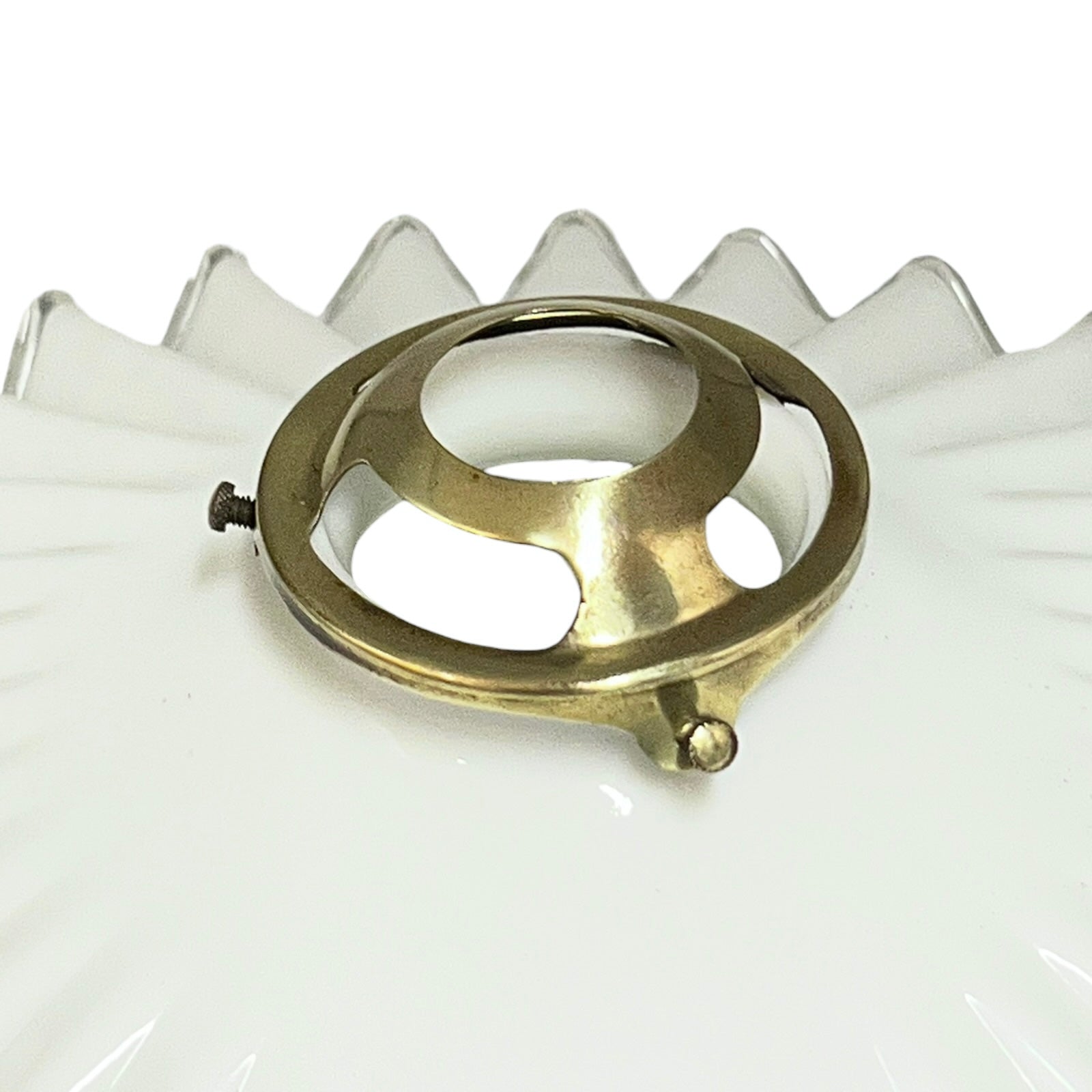 Close up of a White scalloped-edge glass lampshade with brass fitting on a white background, for a period living room styling or vintage home decor 