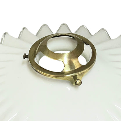 Close up of a White scalloped-edge glass lampshade with brass fitting on a white background, for a period living room styling or vintage home decor 