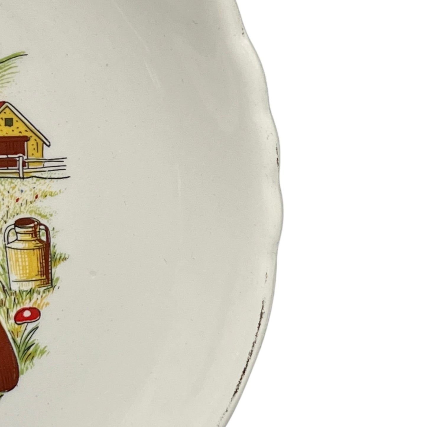 Ceramic plate with farm scene illustration on a white background
