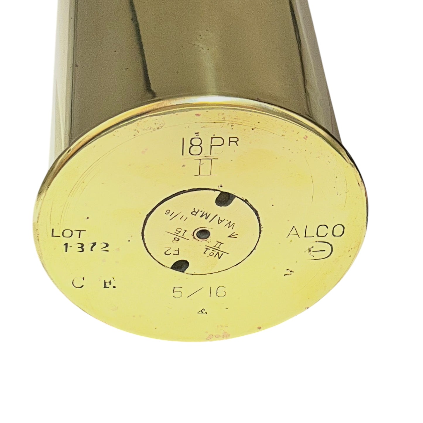 Close-up of the circular brass base of an 18 pounder Alco 18 PR II, showing engraved specifications and markings on a white background.