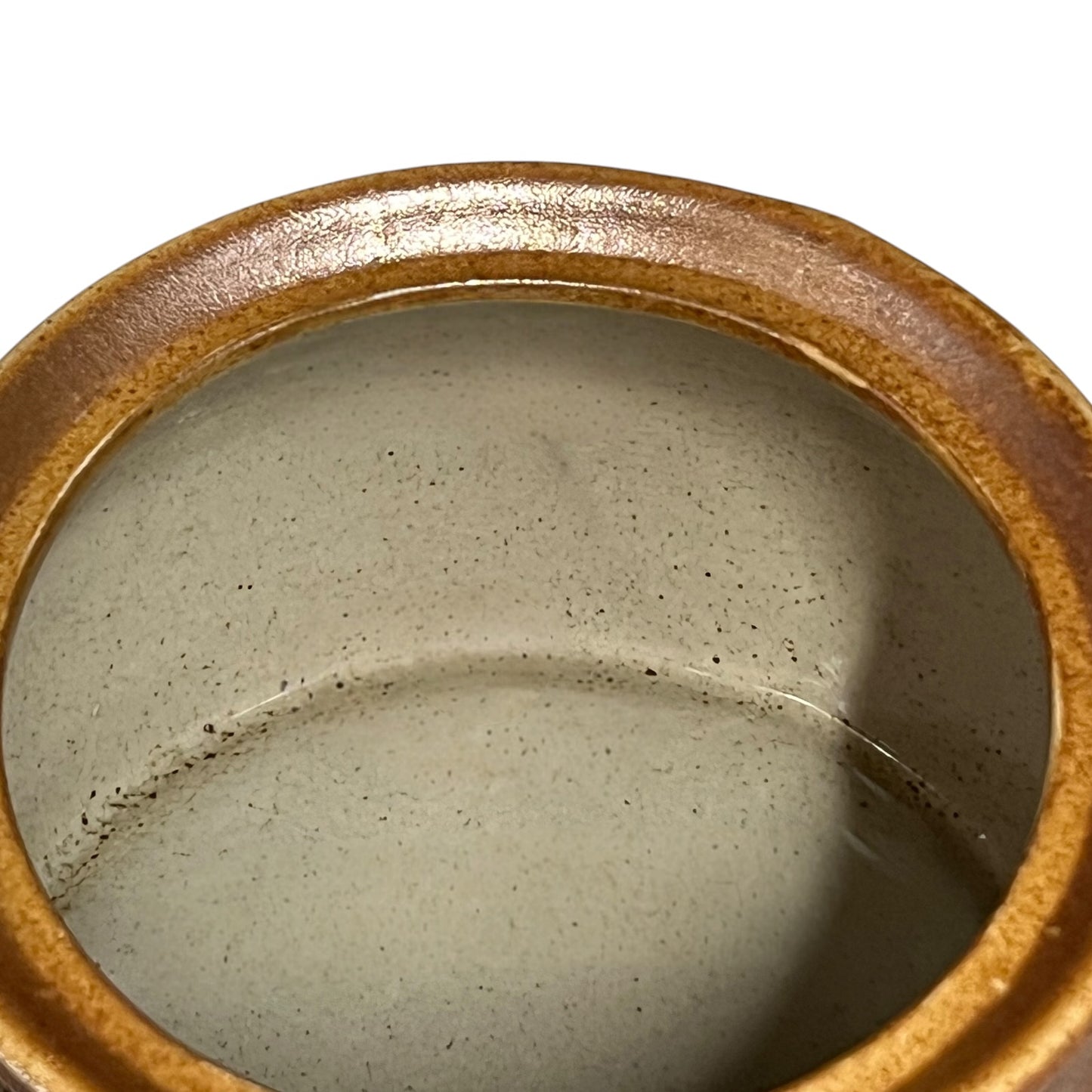Close-up of a ceramic container with 'Olive' engraved on it, on a white background.