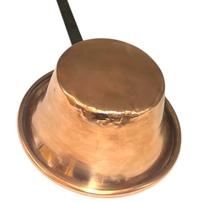 Close up of French vintage copper ladle pan with a black handle on a white background