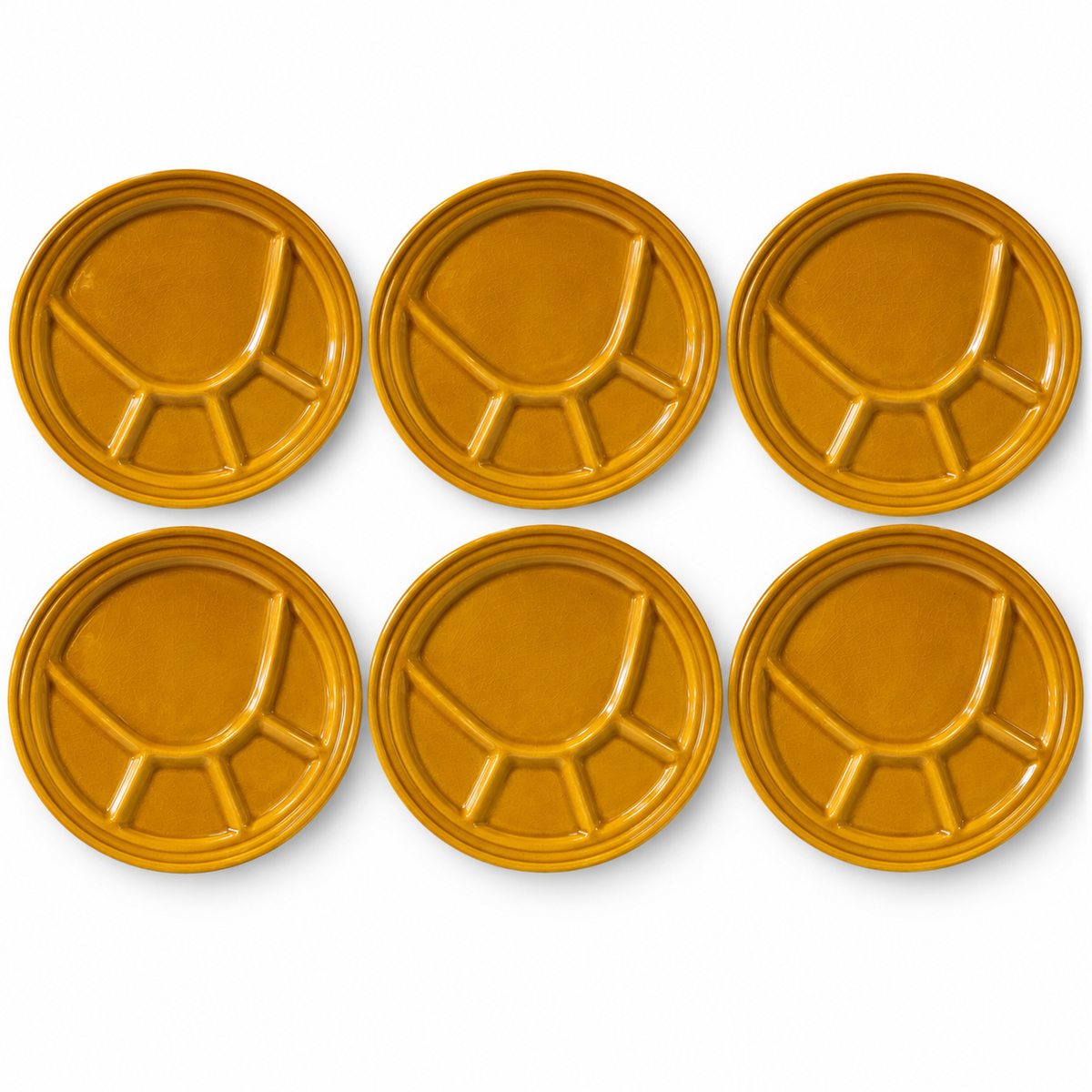 Six round mustard-yellow ceramic plates with a segmented, divided design, arranged in two rows of three on a white background.