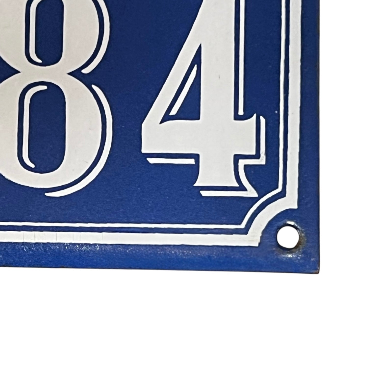 Blue sign with white numbers '384' on a white background