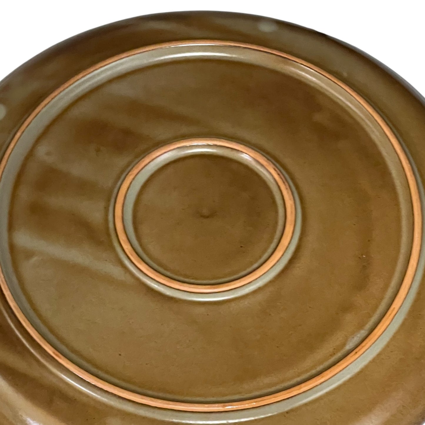 Close-up of a ceramic plate with concentric circle design on a white background