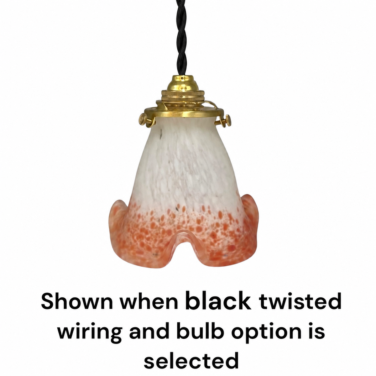 A hanging pendant light shade made of frosted white glass with orange speckling concentrated toward the bottom, attached to a black twisted cord and gold-toned metal fitting. Text below reads: 'Shown when black twisted wiring and bulb option is selected.
