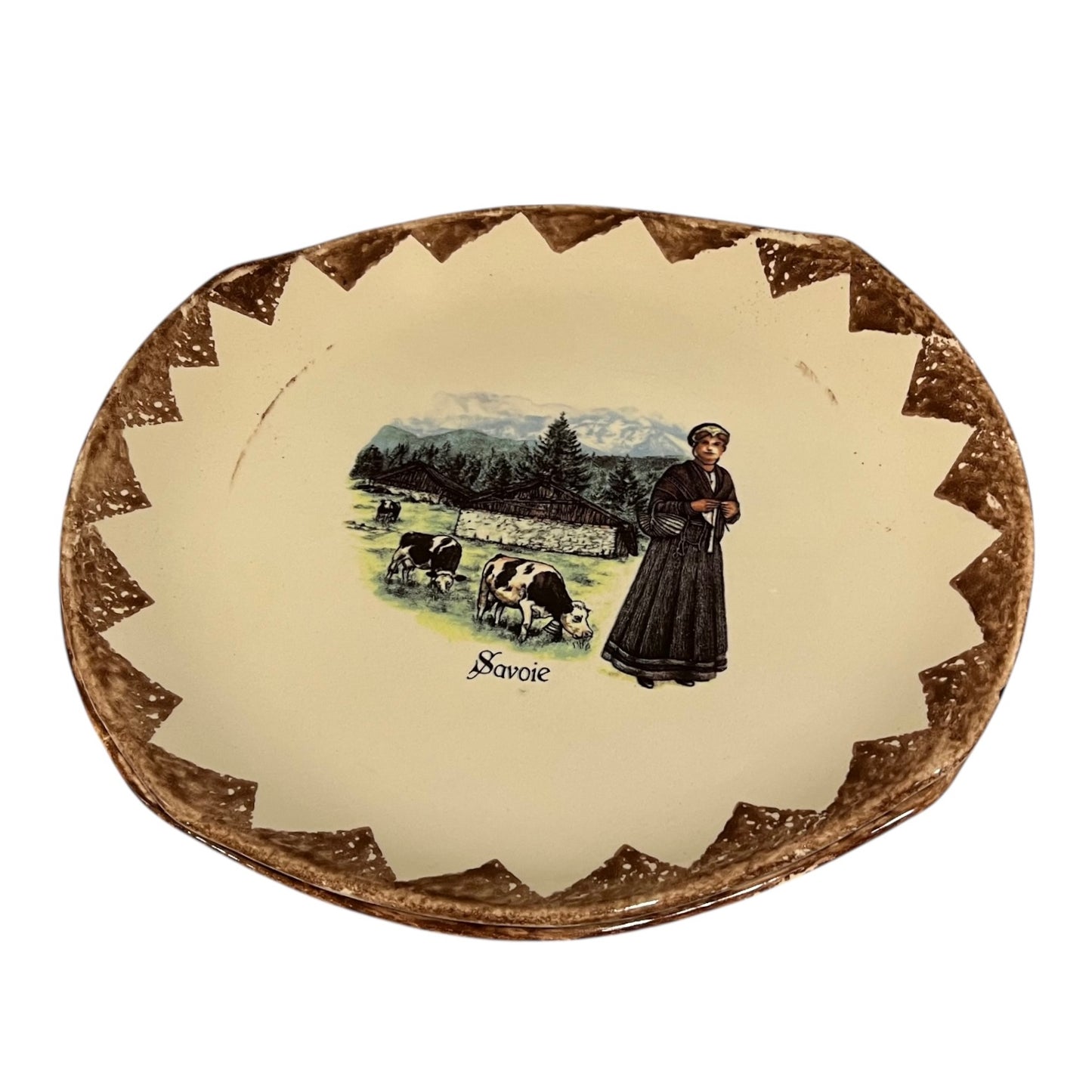 Decorative plate with a woman and cows illustration and 'Savoie' text on a beige background.