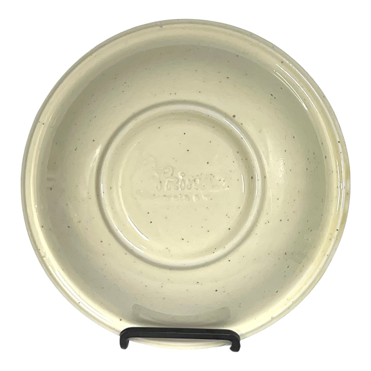 Beige ceramic bowl with speckled pattern on a white background