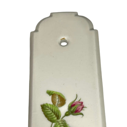 Close up of a finger push plate on a white background