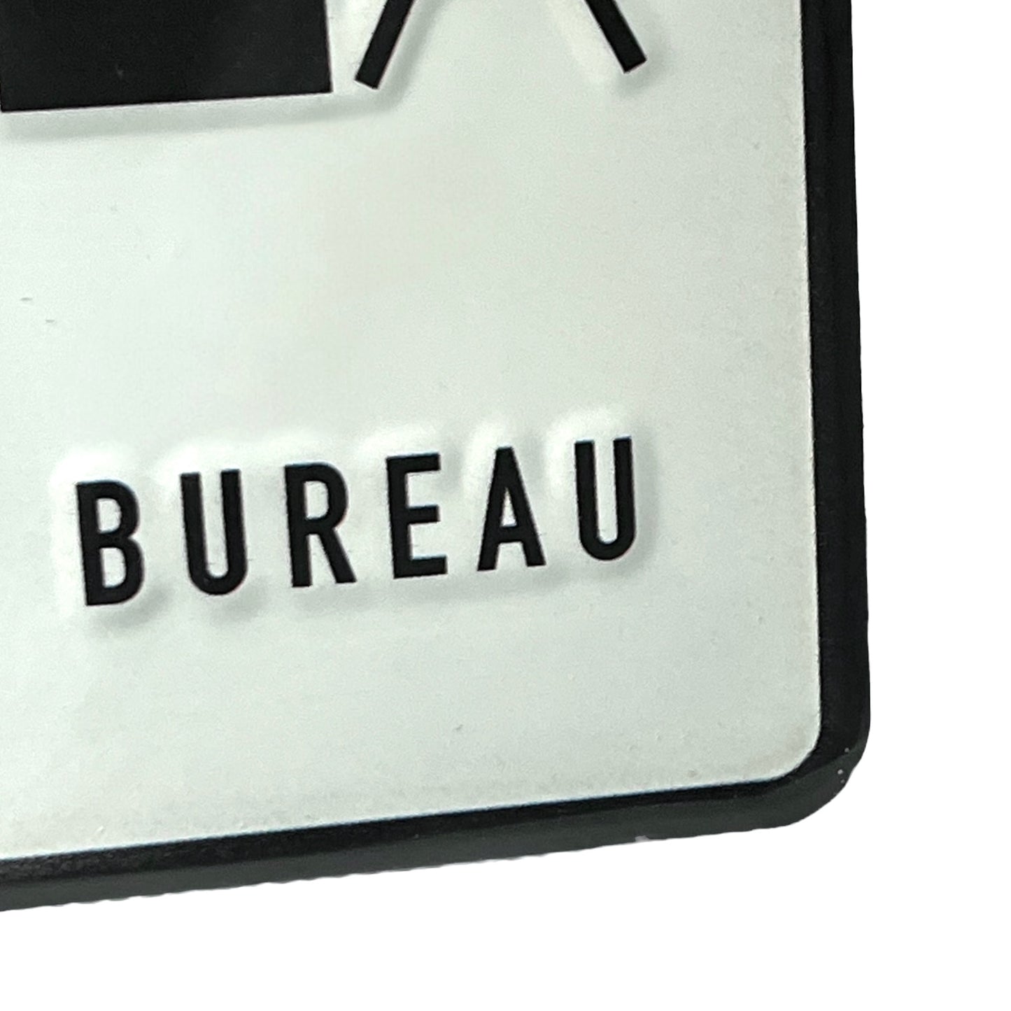 Close-up of a sign with 'BUREAU' text on a white background