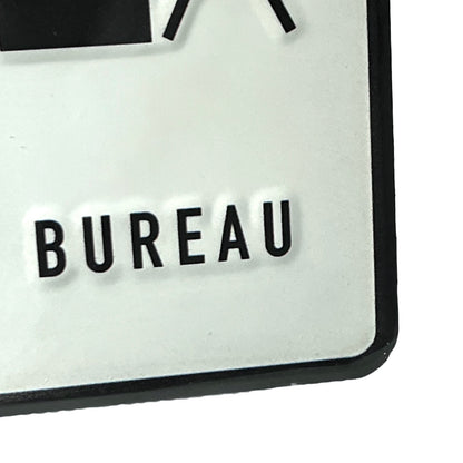 Close-up of a sign with 'BUREAU' text on a white background